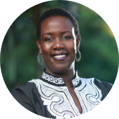 doctor Wanjiru Kamau-Rutenberg smiling at the camera with hoop earrings and formal black and white blouse